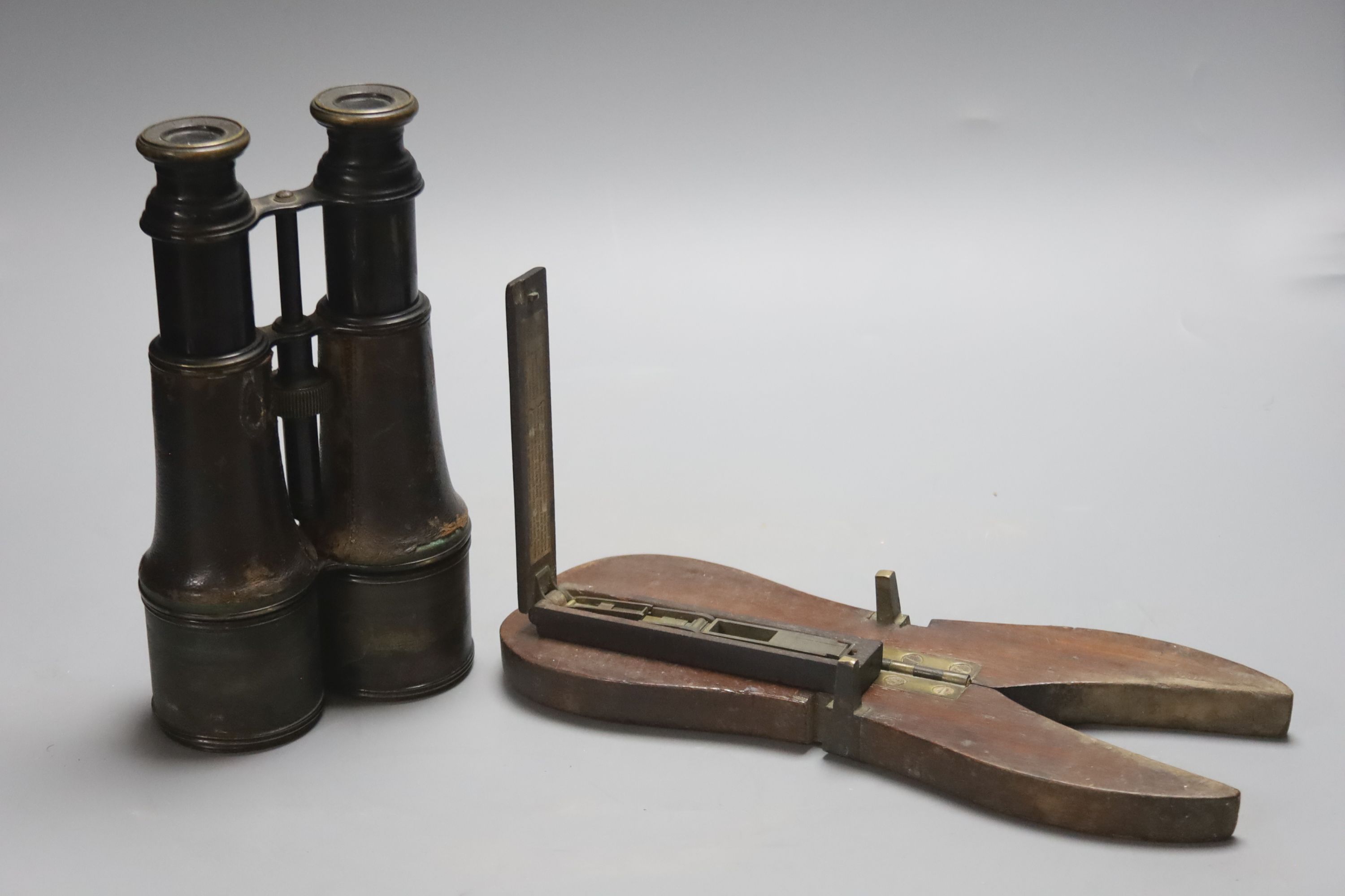 A pair of Lemaire Fab Paris bincoulars, a Georgian sovereign scale and mahogany campaign boot pulls